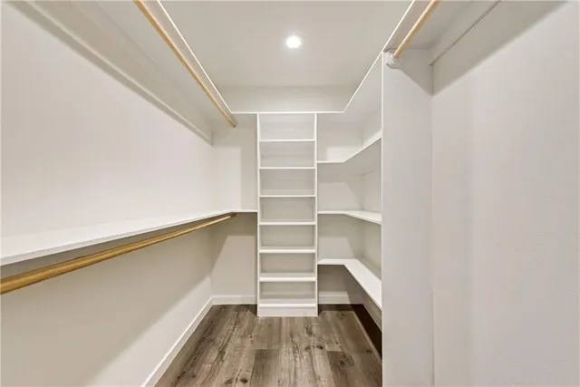a view of walk in closet with empty racks