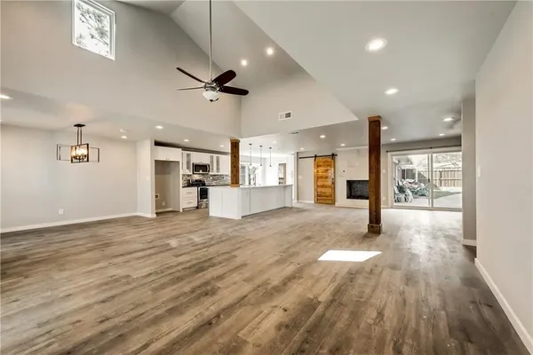 a view of kitchen and hall with wooden floor