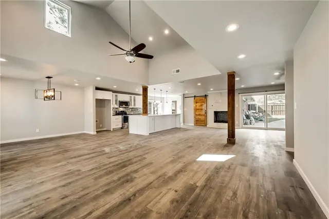 a view of kitchen and hall with wooden floor