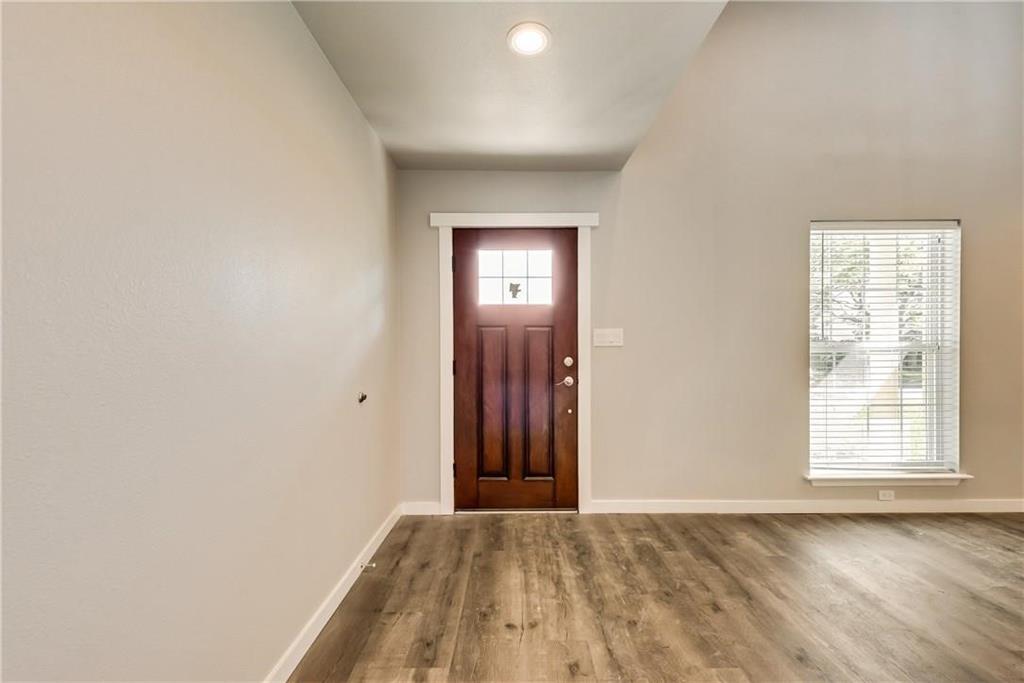 10216 Carry Back Circle Dallas, TX 75229 - Photo 3 of 28 an empty room with wooden floor and windows