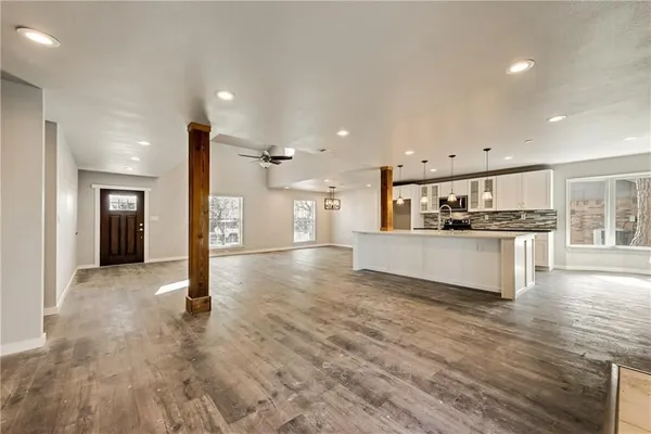 a view of kitchen with cabinets and refrigerator