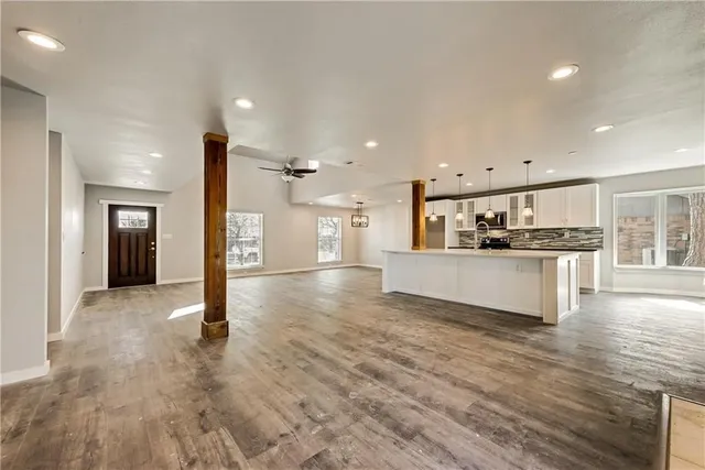a view of kitchen with cabinets and refrigerator