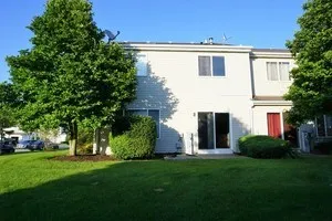 a house with green field in front of it