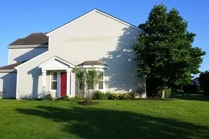 a view of a house with backyard and garden