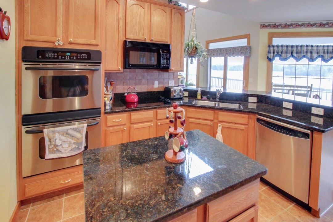 713 Lantz Road Edinburg, VA 22824 - Photo 11 of 27 a kitchen with stainless steel appliances granite countertop a stove a sink and a microwave