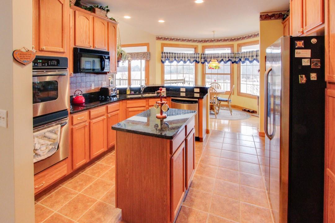 713 Lantz Road Edinburg, VA 22824 - Photo 12 of 27 a kitchen with stainless steel appliances granite countertop a stove and a refrigerator