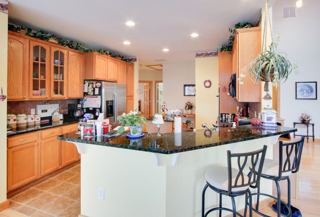 713 Lantz Road Edinburg, VA 22824 - Photo 13 of 27 a kitchen with stainless steel appliances kitchen island granite countertop a table and chairs