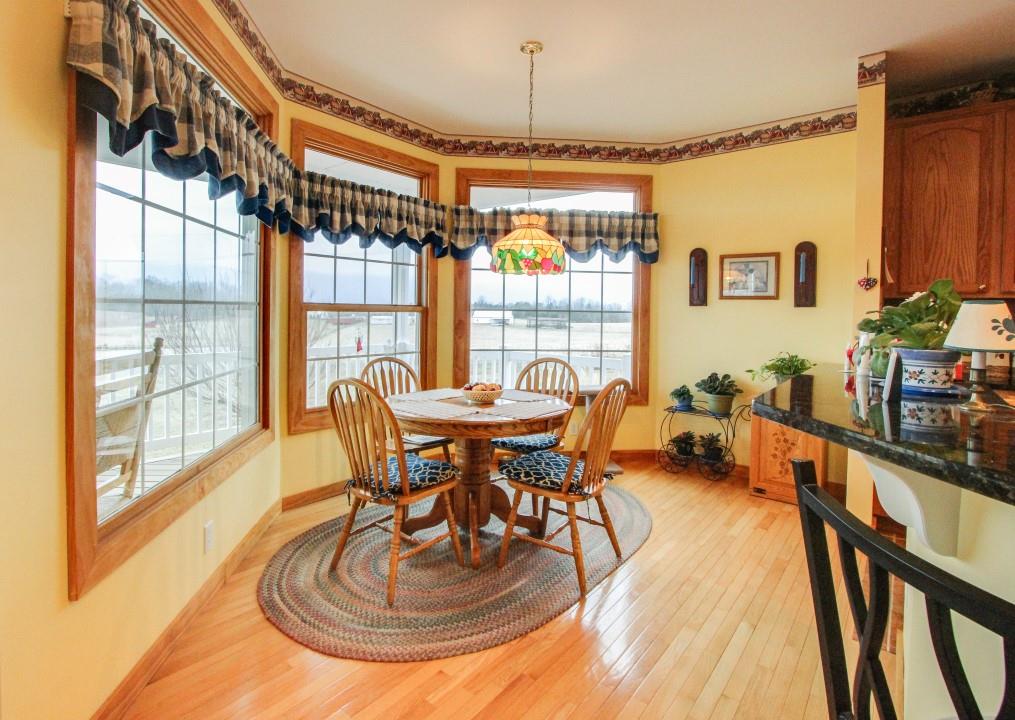 713 Lantz Road Edinburg, VA 22824 - Photo 17 of 27 a dining room with furniture a chandelier and wooden floor