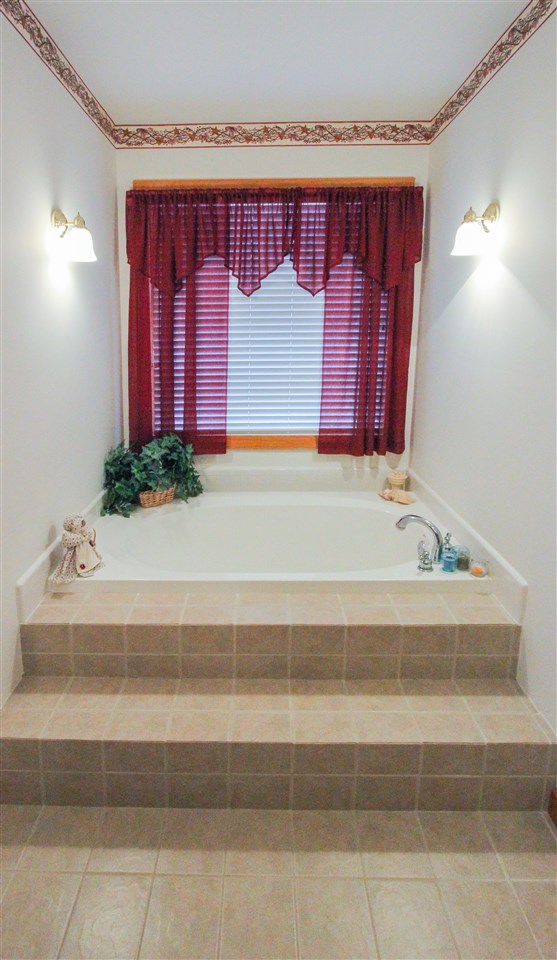 713 Lantz Road Edinburg, VA 22824 - Photo 19 of 27 a bathroom with a bathtub and shower