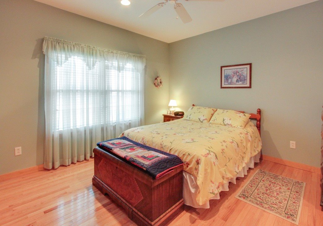 713 Lantz Road Edinburg, VA 22824 - Photo 20 of 27 a bed sitting in a bedroom next to a window