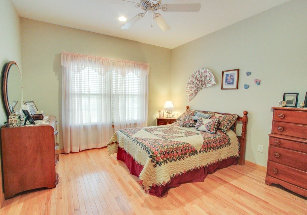 713 Lantz Road Edinburg, VA 22824 - Photo 21 of 27 a bedroom with a bed and a dresser with wooden floor