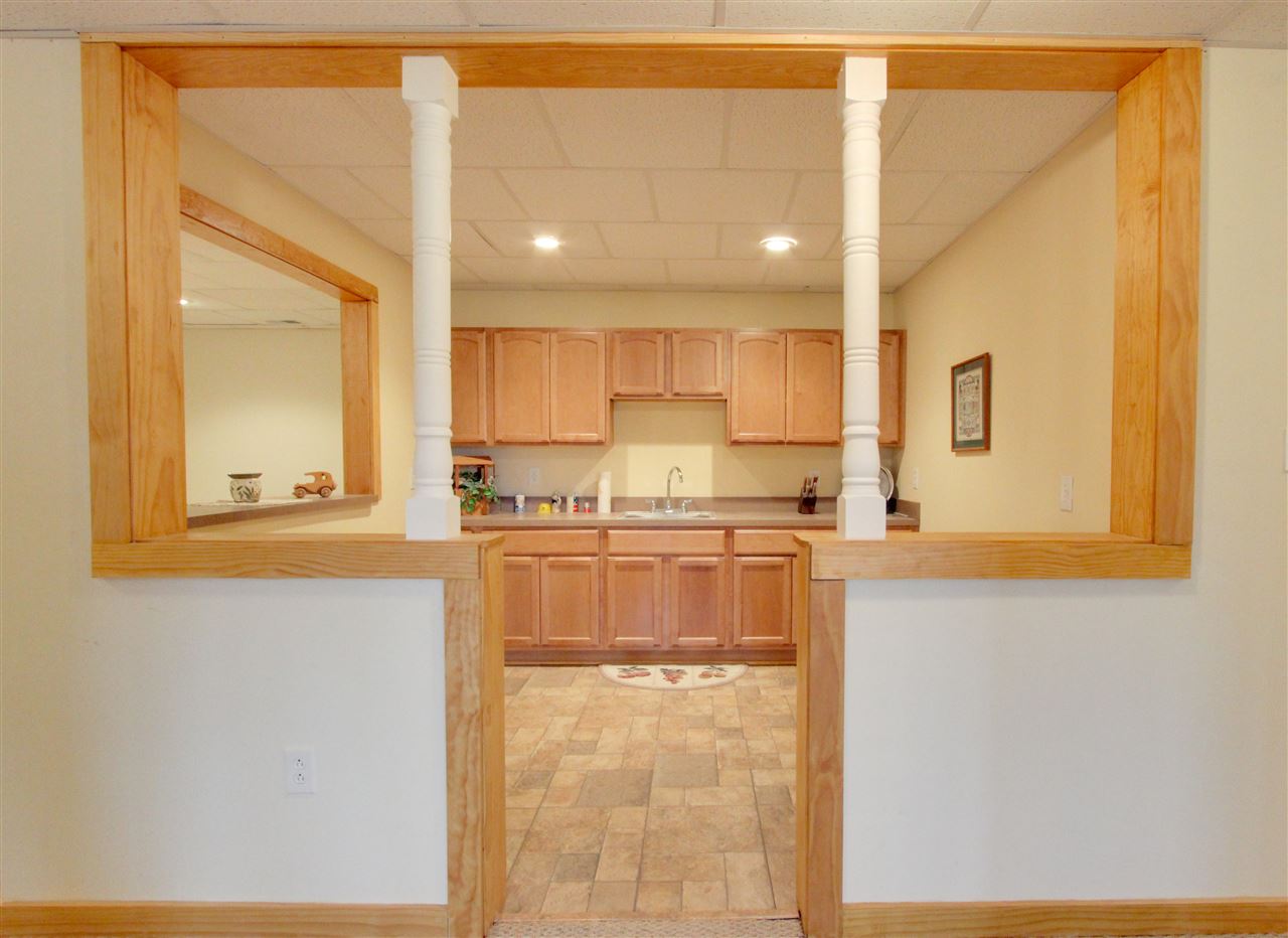 713 Lantz Road Edinburg, VA 22824 - Photo 25 of 27 a kitchen with stainless steel appliances granite countertop a sink and a refrigerator