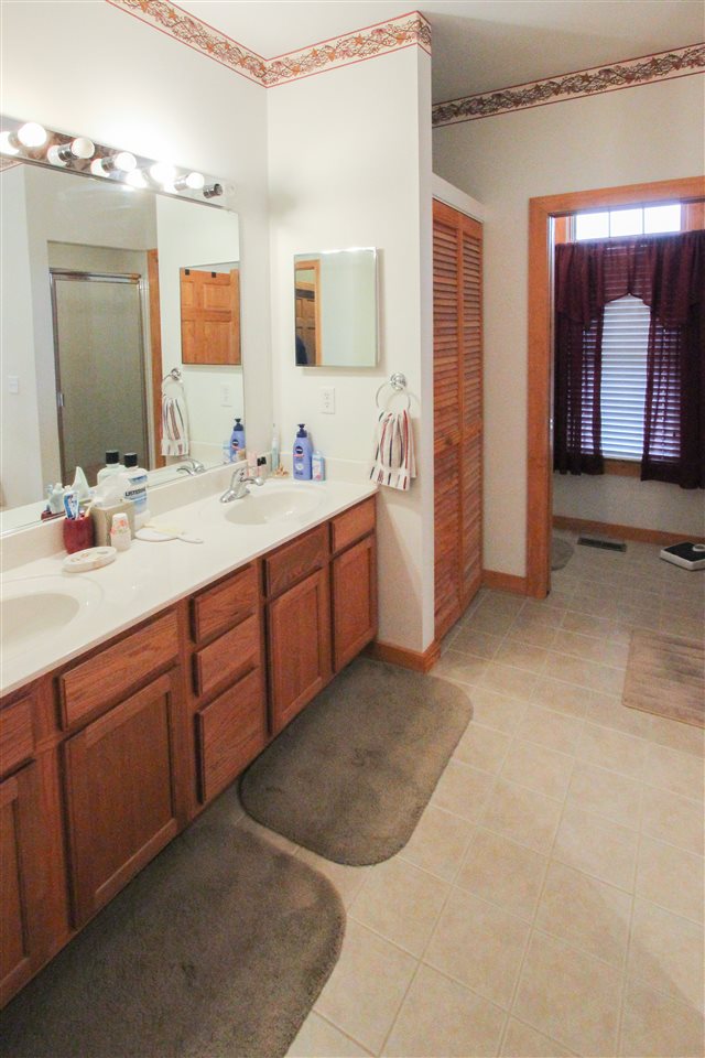 713 Lantz Road Edinburg, VA 22824 - Photo 26 of 27 a spacious bathroom with a double vanity sink mirror and
