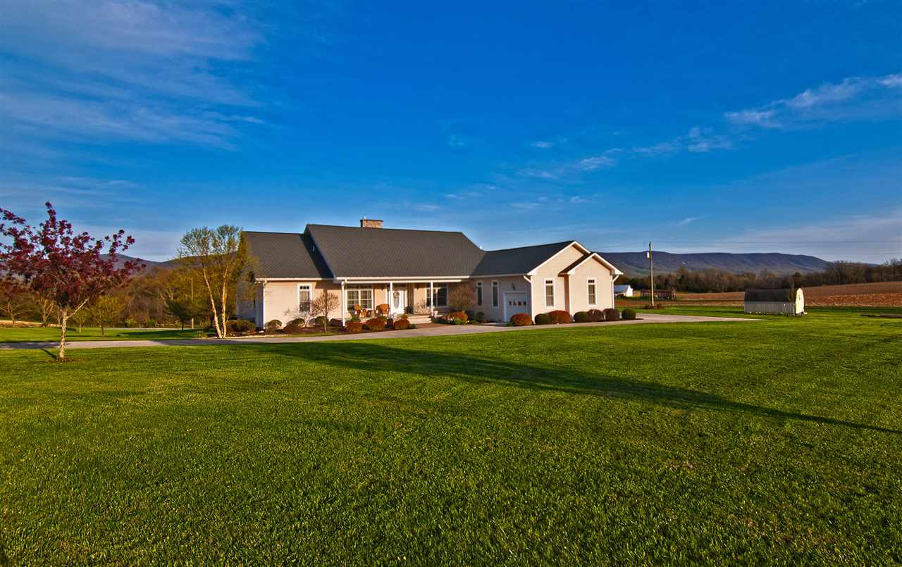 713 Lantz Road Edinburg, VA 22824 - Photo 3 of 27 a view of a big house with a big yard and large trees