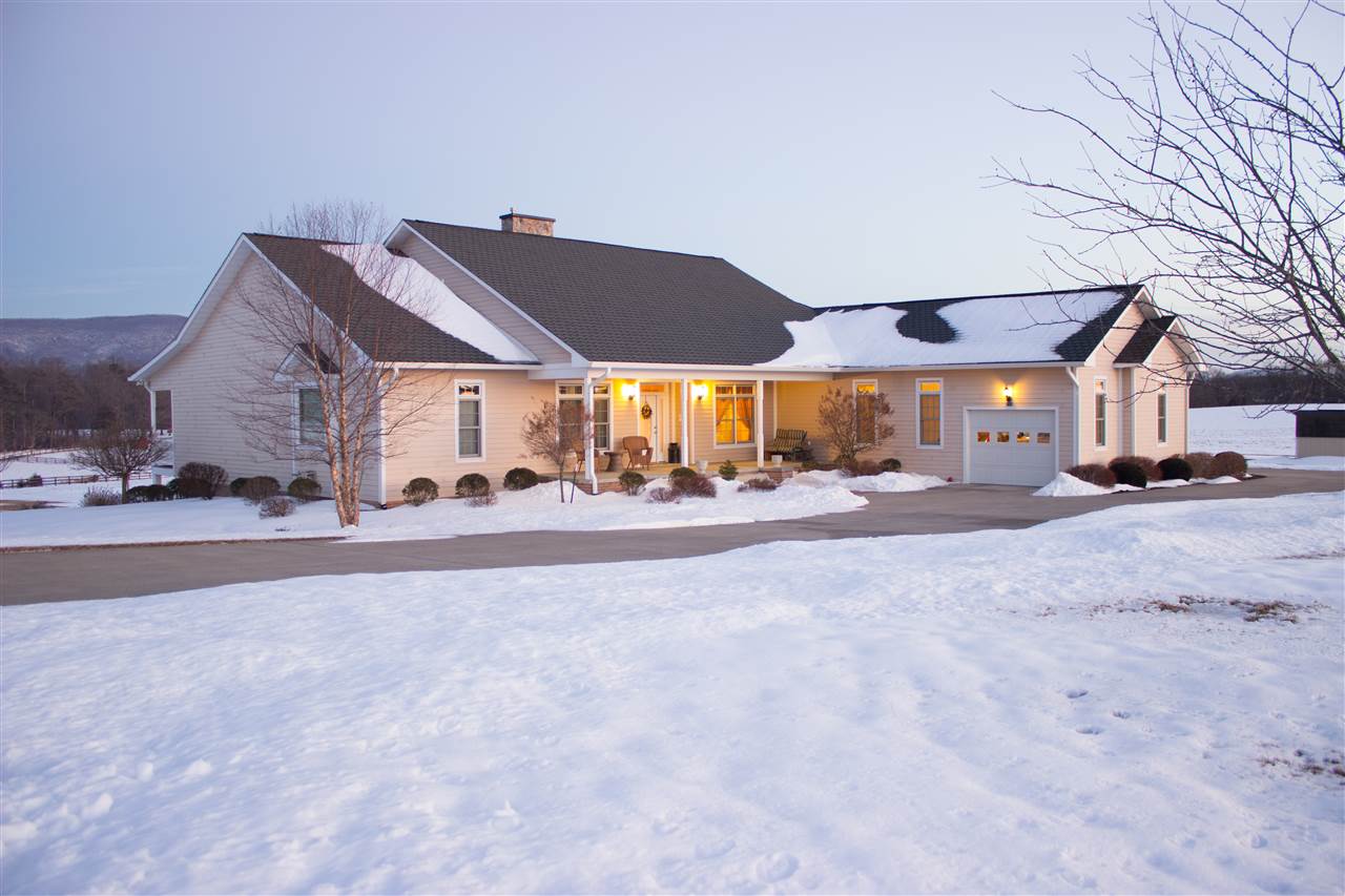 713 Lantz Road Edinburg, VA 22824 - Photo 6 of 27 a view of a white house with a big yard and large trees