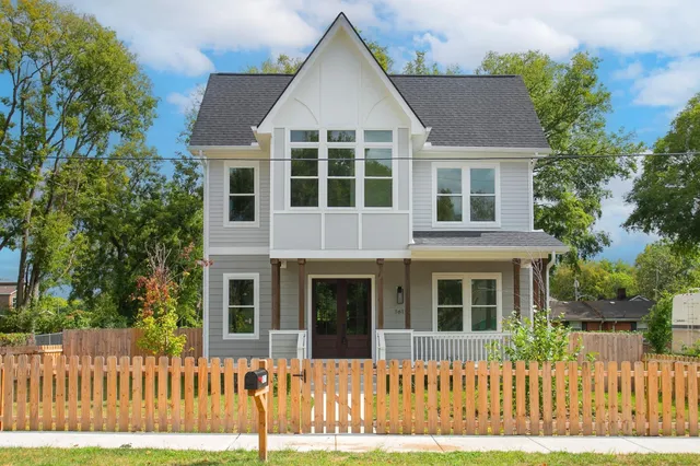 a front view of a house with a fence