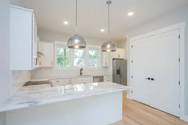 a kitchen with a sink stove and cabinets