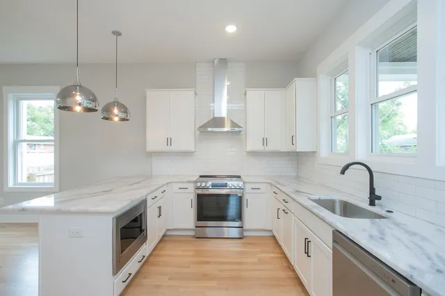 a view of a kitchen center island and wooden floor