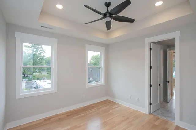 wooden floor in an empty room with a bathroom