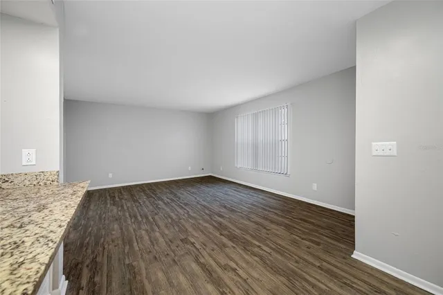a view of an empty room and wooden floor