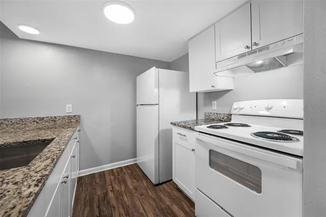 a kitchen with a stove and a refrigerator