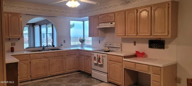 a kitchen with a sink cabinets and window