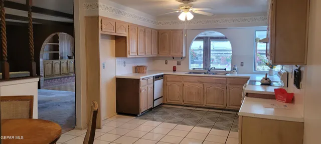 a view of a kitchen with a sink and cabinets