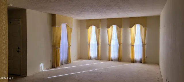 a view of room with windows and closet