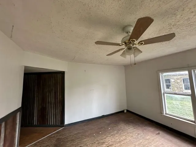 a view of a livingroom with a ceiling fan and window