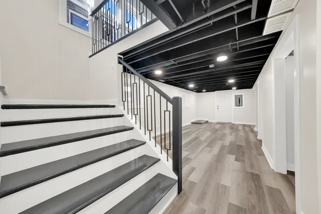 a view of a room with wooden floor and a window