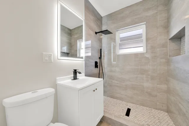 a bathroom with a sink toilet and shower