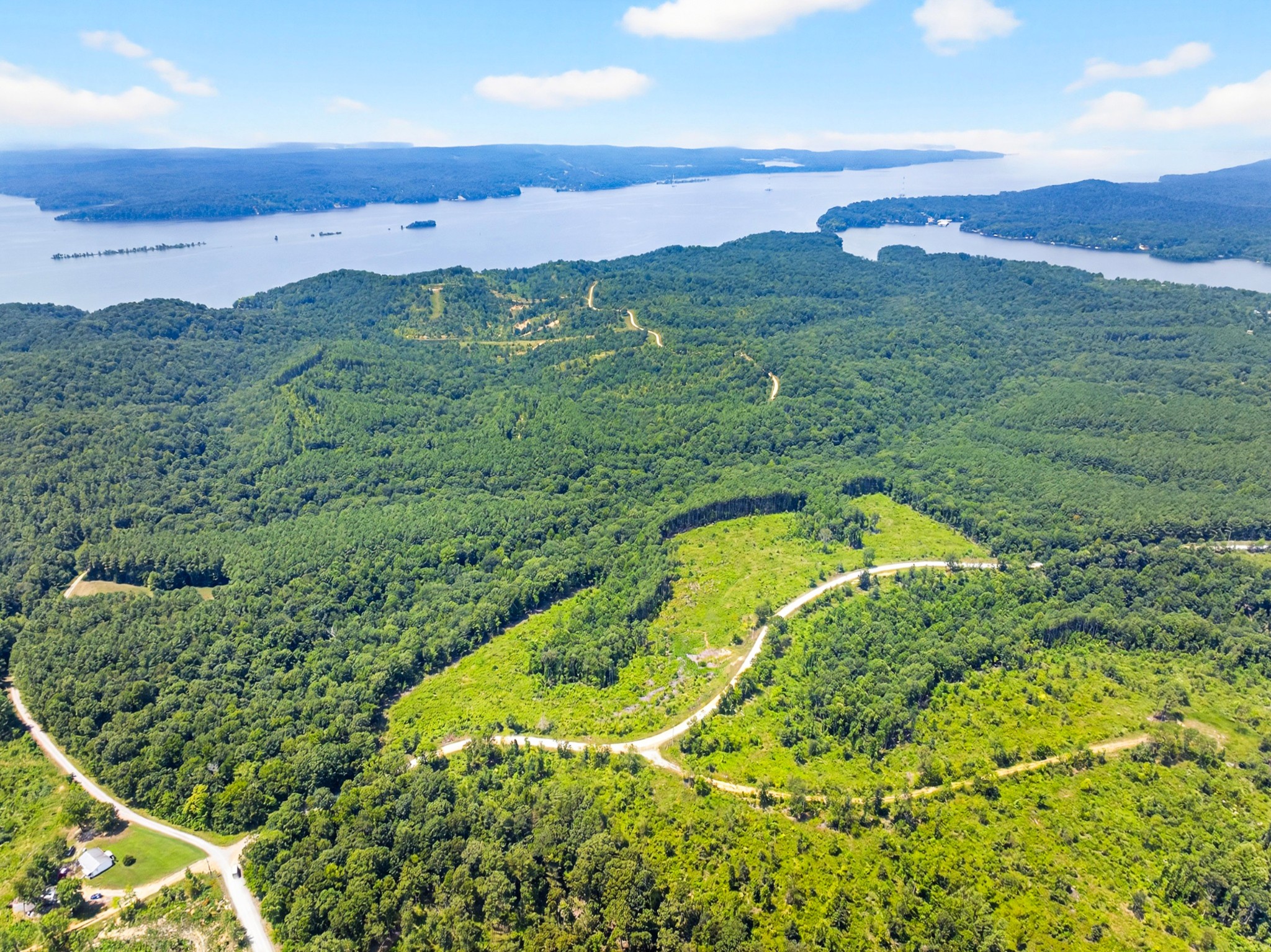 a view of a lush green hillside and an ocean view