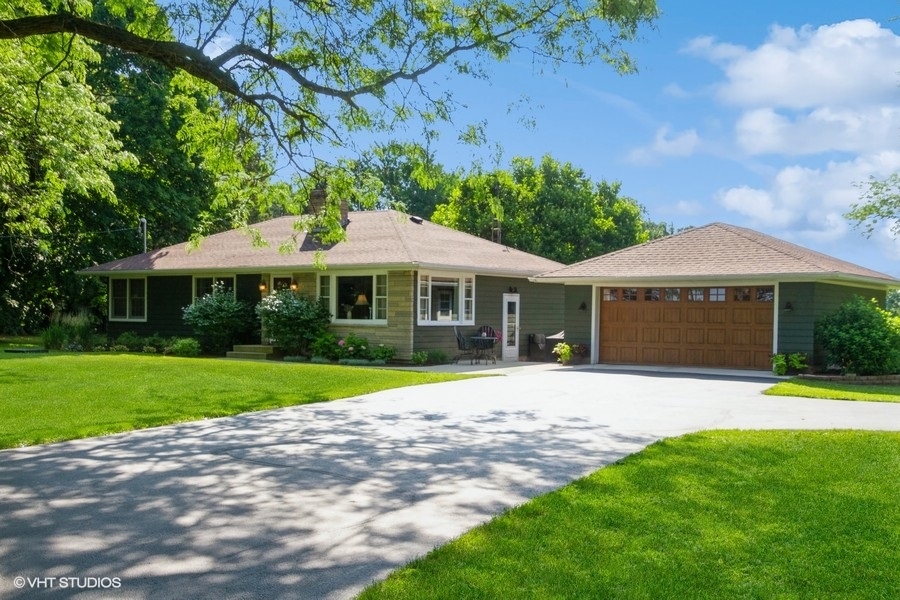 a front view of a house with a yard and pathway