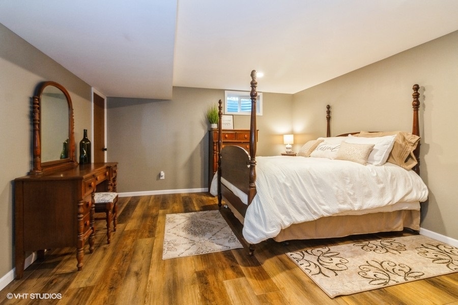 5602 Pagles Road Harvard, IL 60033 - Photo 15 of 23 a bedroom with a bed and wooden floor