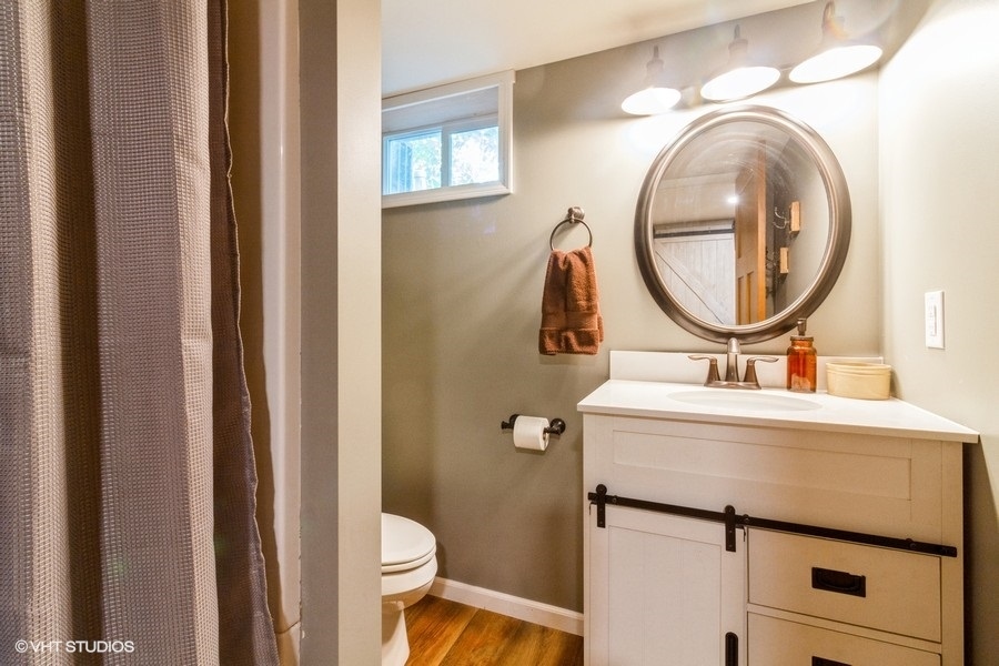5602 Pagles Road Harvard, IL 60033 - Photo 16 of 23 a bathroom with a toilet a sink and a mirror