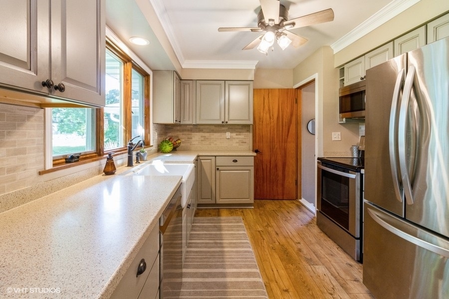 5602 Pagles Road Harvard, IL 60033 - Photo 6 of 23 a kitchen with stainless steel appliances a refrigerator sink and cabinets