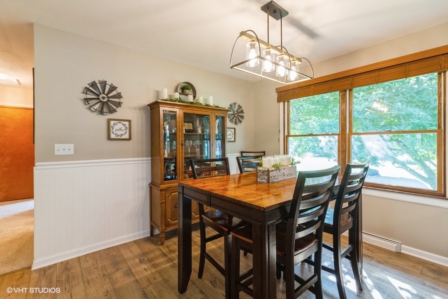 5602 Pagles Road Harvard, IL 60033 - Photo 7 of 23 a dining room with furniture a rug and a chandelier