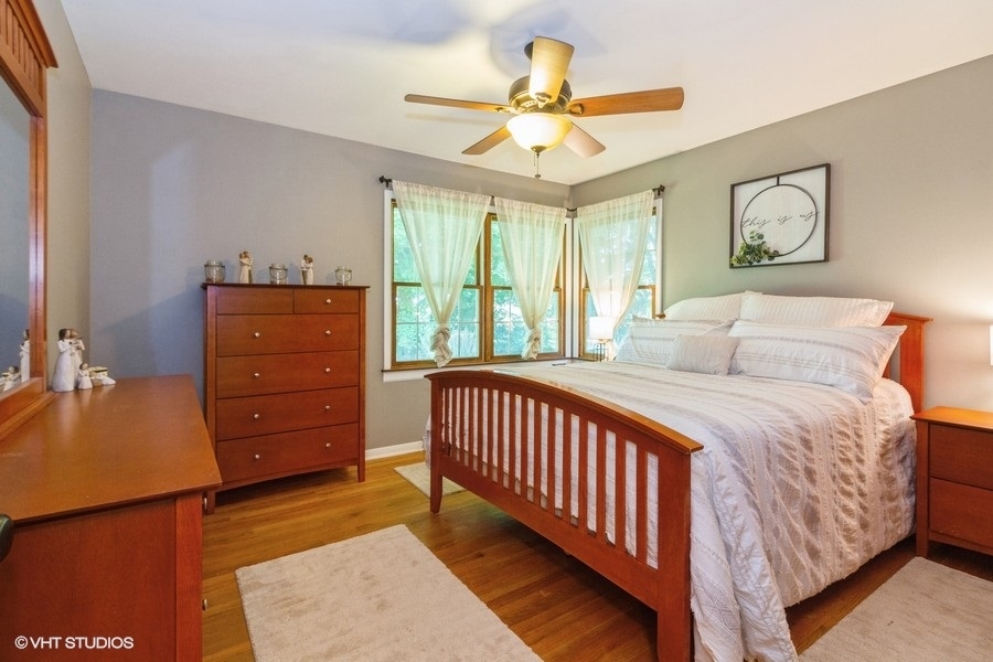 5602 Pagles Road Harvard, IL 60033 - Photo 8 of 23 a bedroom with a bed and a chandelier