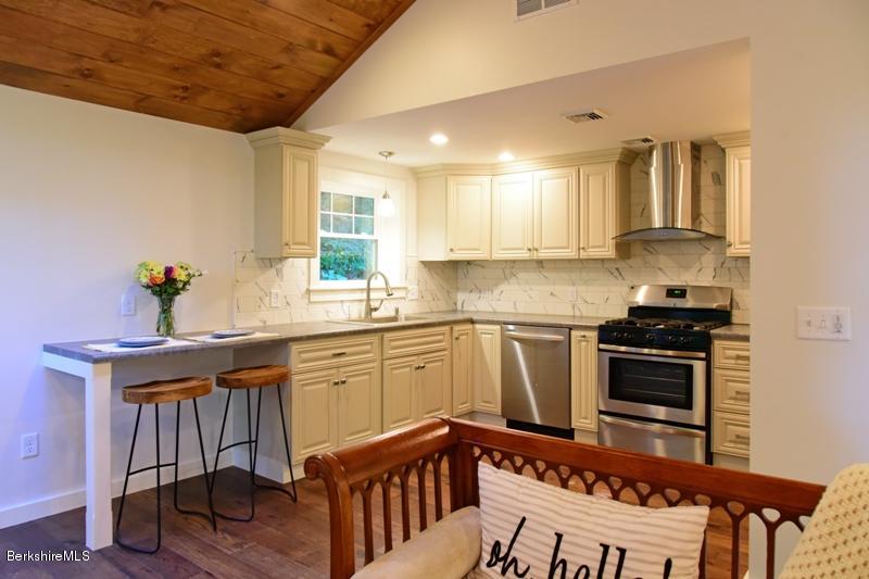 16 Mahkeenac Road Stockbridge, MA 01262 - Photo 13 of 26 a kitchen with stainless steel appliances granite countertop a sink and cabinets