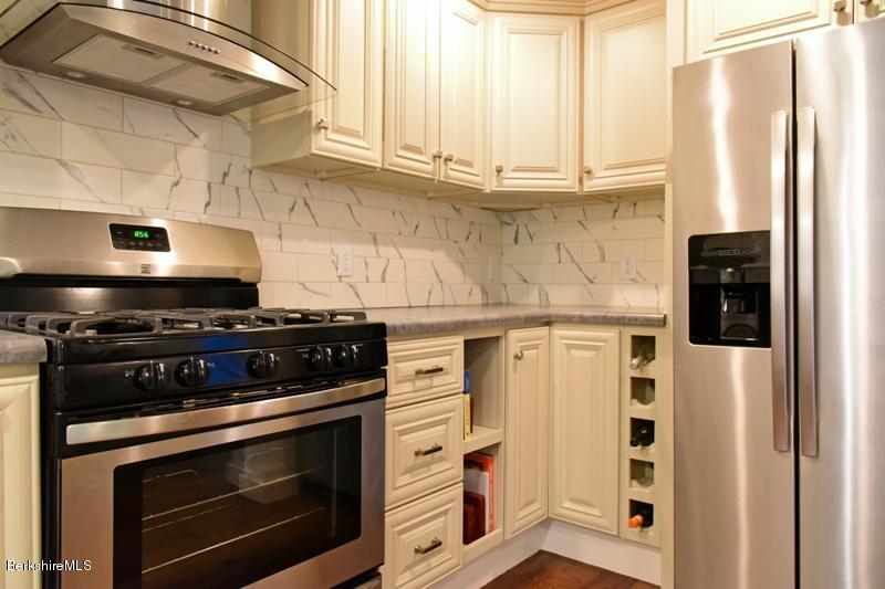 16 Mahkeenac Road Stockbridge, MA 01262 - Photo 17 of 26 a kitchen with stainless steel appliances a stove and a refrigerator