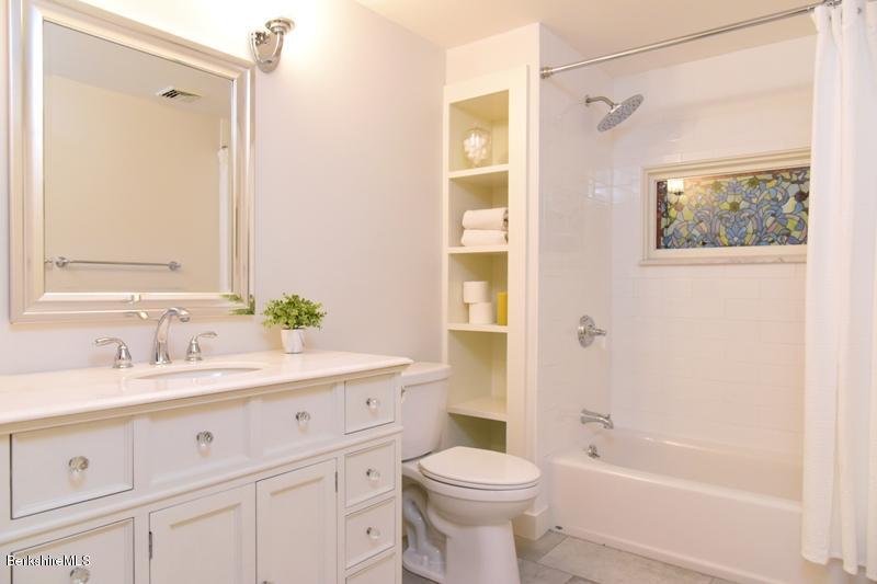 16 Mahkeenac Road Stockbridge, MA 01262 - Photo 24 of 26 a bathroom with a sink a toilet and a large mirror