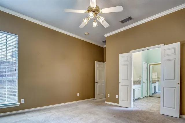 a view of a livingroom with a chandelier fan and windows