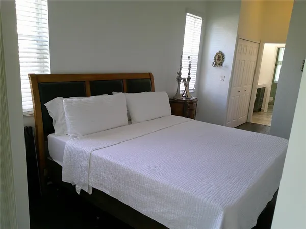 a bedroom with a bed and window