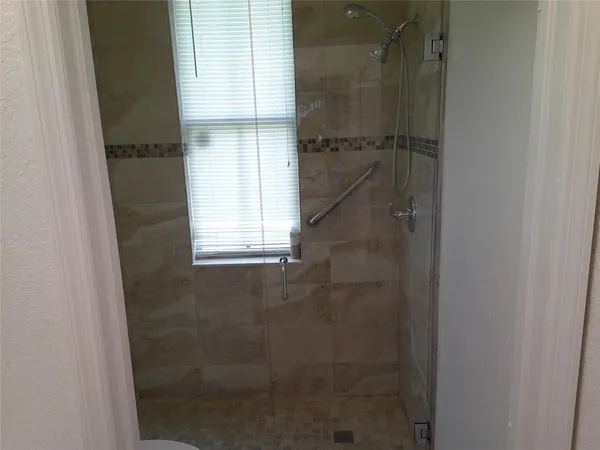 a bathroom with a glass shower door