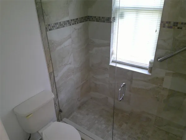 a bathroom with a shower and toilet