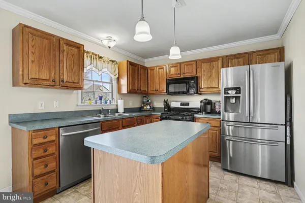 a view of dining room and kitchen with a table chairs and a chandelier