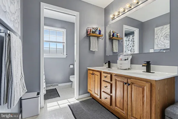 a white toilet sitting next to a window