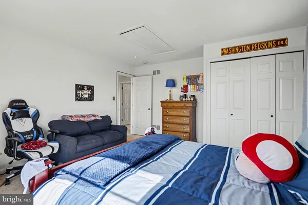 a spacious bedroom with a bed and window