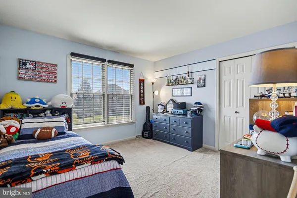 a bedroom with bed and closet