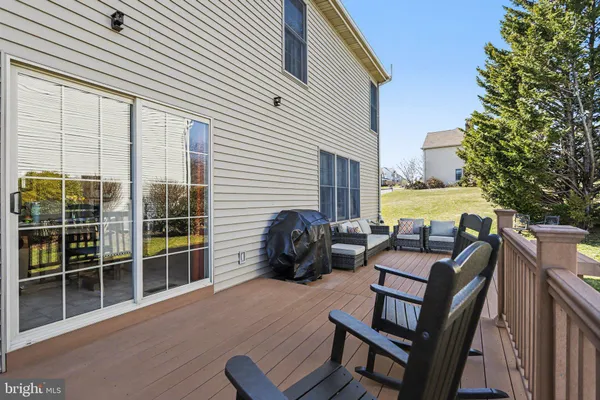 a view of a patio with dining table and chairs